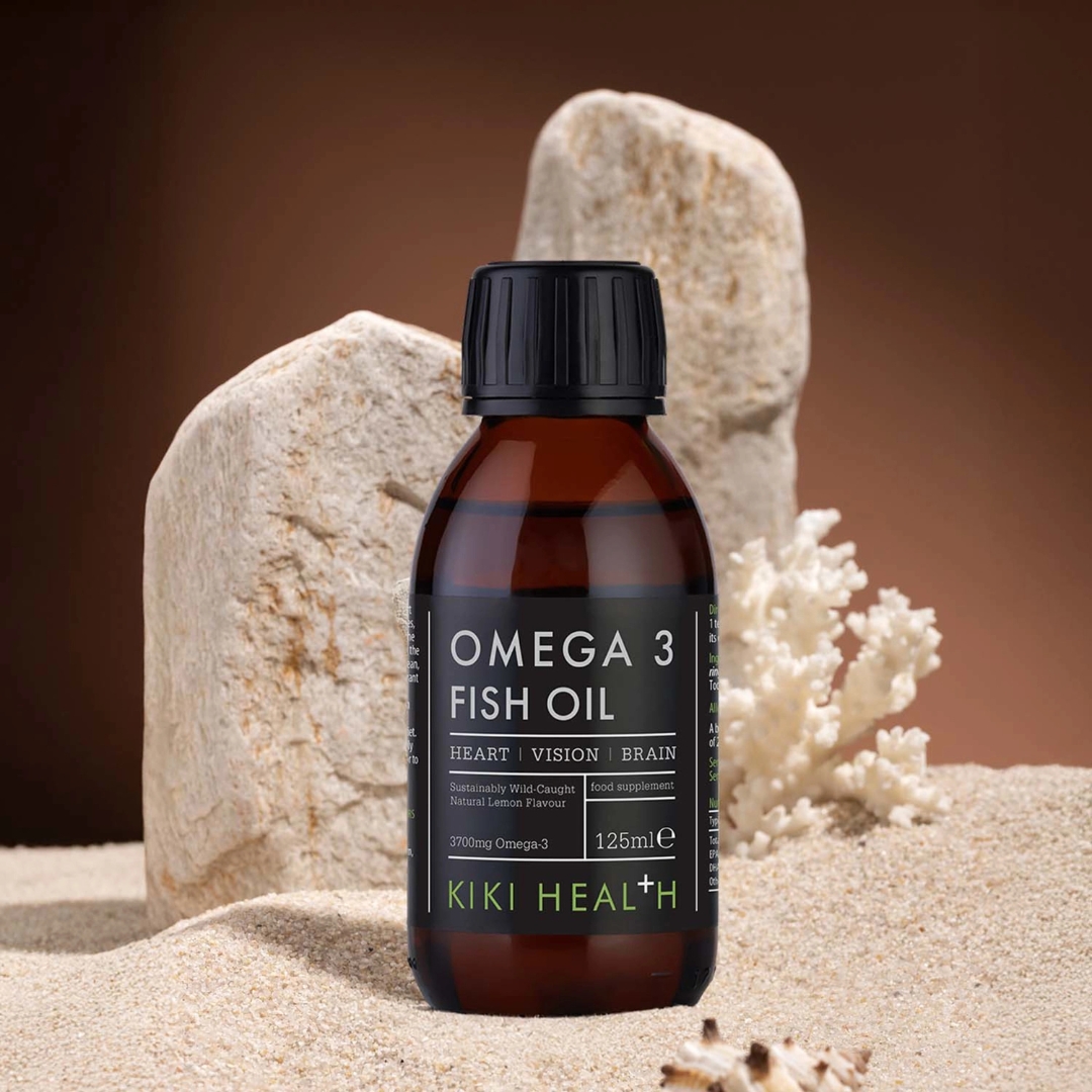 KIKI Health Omega 3 Fish Oil bottle placed among rocks and coral to highlight marine origin and sustainability
