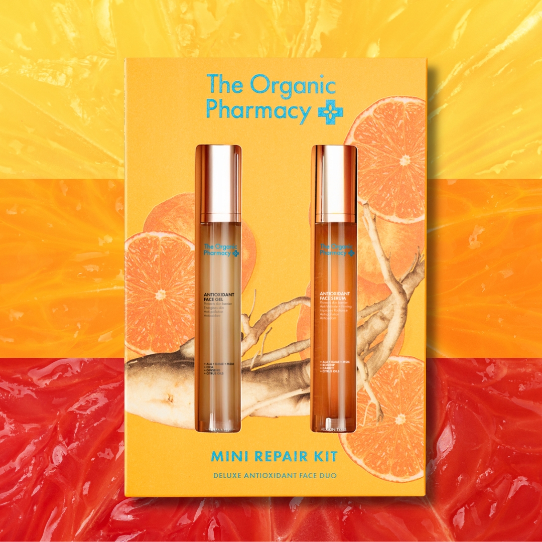 The Organic Pharmacy Mini Repair Kit antioxidant skincare duo displayed on citrus background